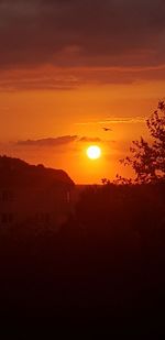 Scenic view of silhouette landscape against romantic sky at sunset