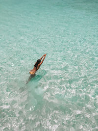 High angle view of woman swimming in sea