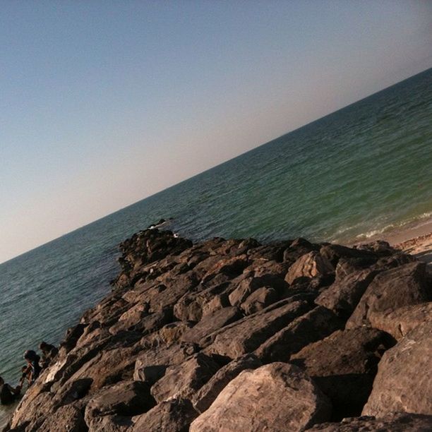 sea, horizon over water, water, scenics, tranquil scene, rock - object, tranquility, beauty in nature, nature, clear sky, rock formation, rock, copy space, idyllic, beach, shore, sky, cliff, seascape, outdoors