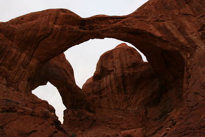 Low angle view of rock formations against sky at arches national park