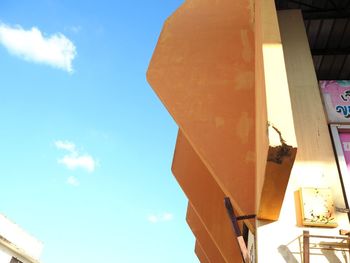 Low angle view of electric lamp against sky