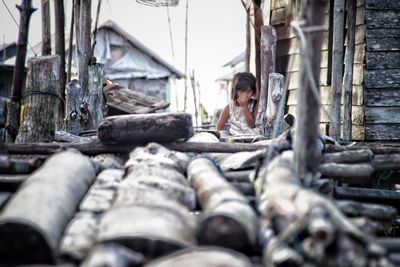 Full length of young woman on stack of building