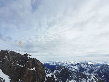 Scenic view of mountains against cloudy sky