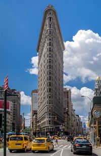 Cars and taxis on street leading towards flatiron building