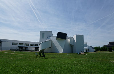 Built structure on field against sky