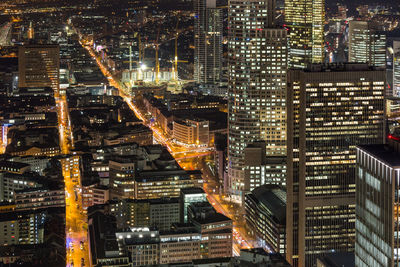 Aerial view of illuminated buildings in city at night