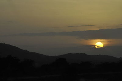 Scenic view of silhouette mountains against sky at sunset