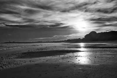 Scenic view of beach against sky during sunset