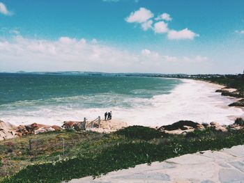 View of beach against cloudy sky
