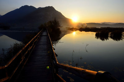 Scenic view of lake against sky during sunset