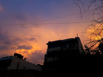 Low angle view of silhouette buildings against sky during sunset