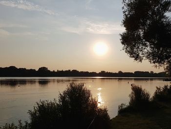 Scenic view of lake against sky during sunset