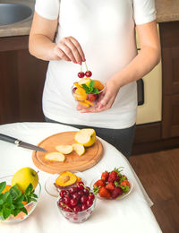 Midsection of woman preparing food on table