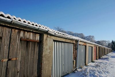 Built structure on snow covered roof against clear sky