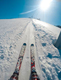 Low section of person on snow covered snowcapped mountain