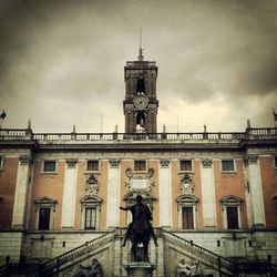 Low angle view of building against cloudy sky