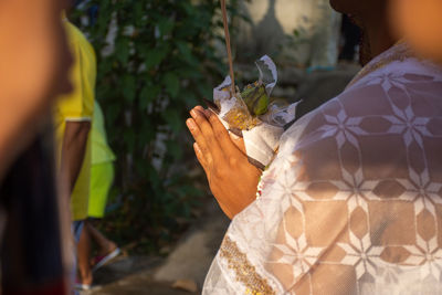 Midsection of woman holding plant