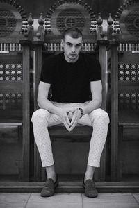 Portrait of young man sitting on seat