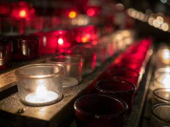 Close-up of lit tea light candles on table