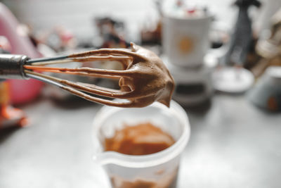 Close-up of dessert on wire whisk