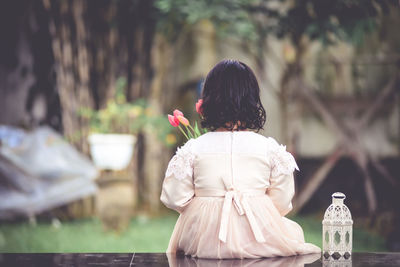 Rear view of girl standing outdoors