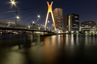 Suspension bridge over river at night