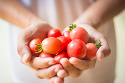 Close-up of woman holding tomatoes