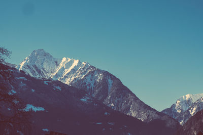 Low angle view of mountains against clear blue sky