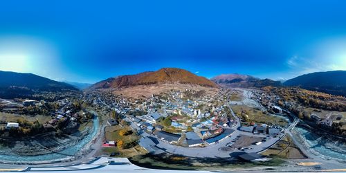 Aerial view of mountains against blue sky