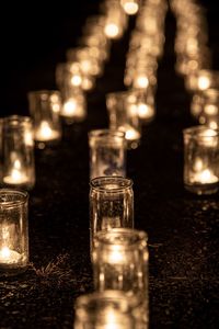 Close-up of illuminated tea light candles at night