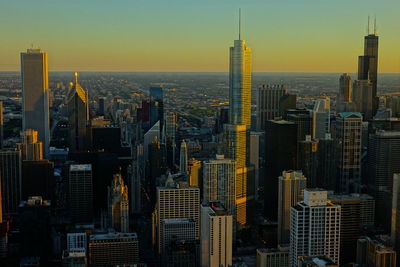 Aerial view of buildings in city during sunset