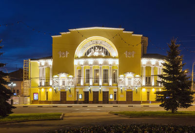 Illuminated building against sky at night