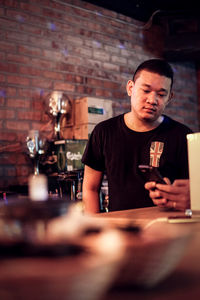 Male bartender working in bar