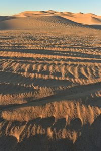 Scenic view of desert against sky during sunset