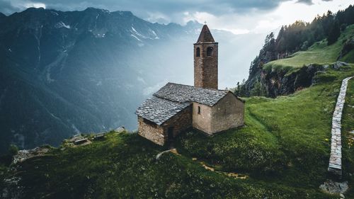 Temple against building and mountains