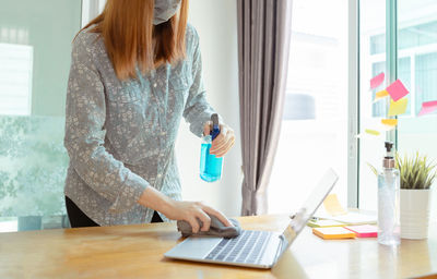 Woman working on table at home