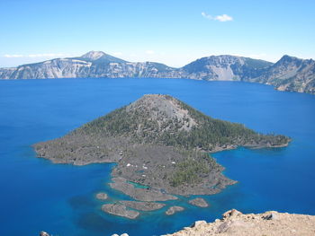 Scenic view of sea and mountains against sky