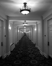 Empty corridor in illuminated building