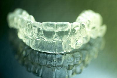Close-up of plastic dentures on glass table