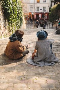 Rear view of couple sitting outdoors