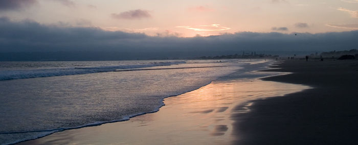 Scenic view of beach against sky during sunset