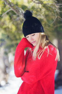 Portrait of young woman standing outdoors