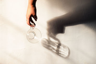 High angle view of person drinking glass on table