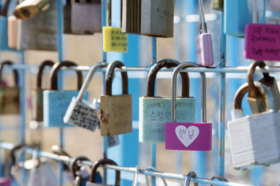 Close-up of love locks hanging on railing