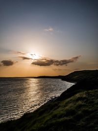 Scenic view of sea against sky at sunset