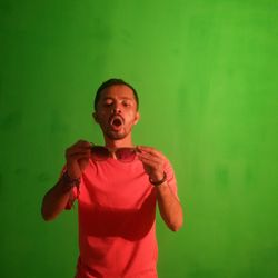 Full length of man standing against wall