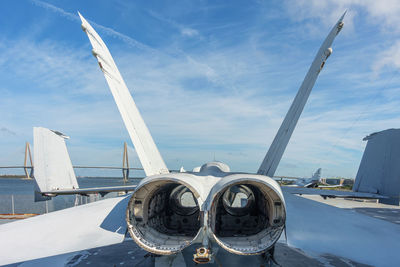 Airplane on runway against sky