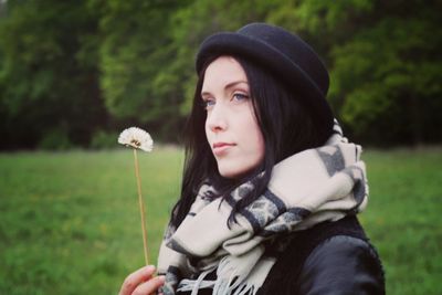 Portrait of woman looking away on field