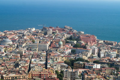 High angle view of townscape by sea against sky