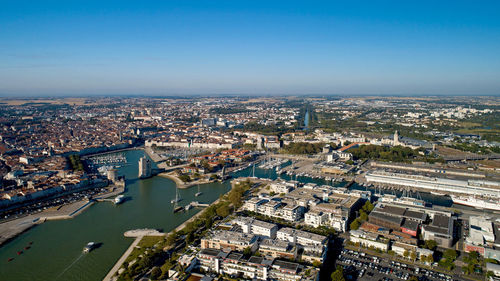 High angle view of illuminated city by buildings against sky